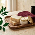 Brand-colored spa cover with soap and an open jar of body butter